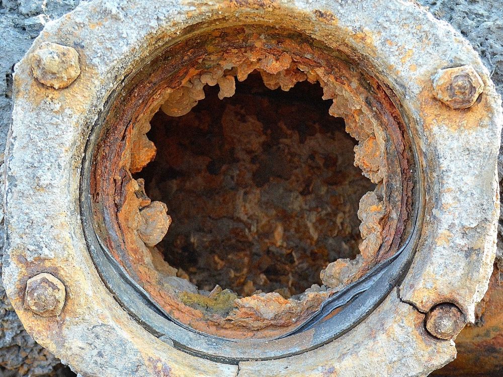 Old sewer pipe with build up inside that reduces flow